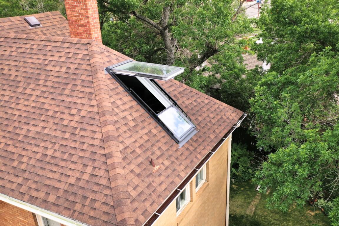 A view of the attic from the outside with the window open